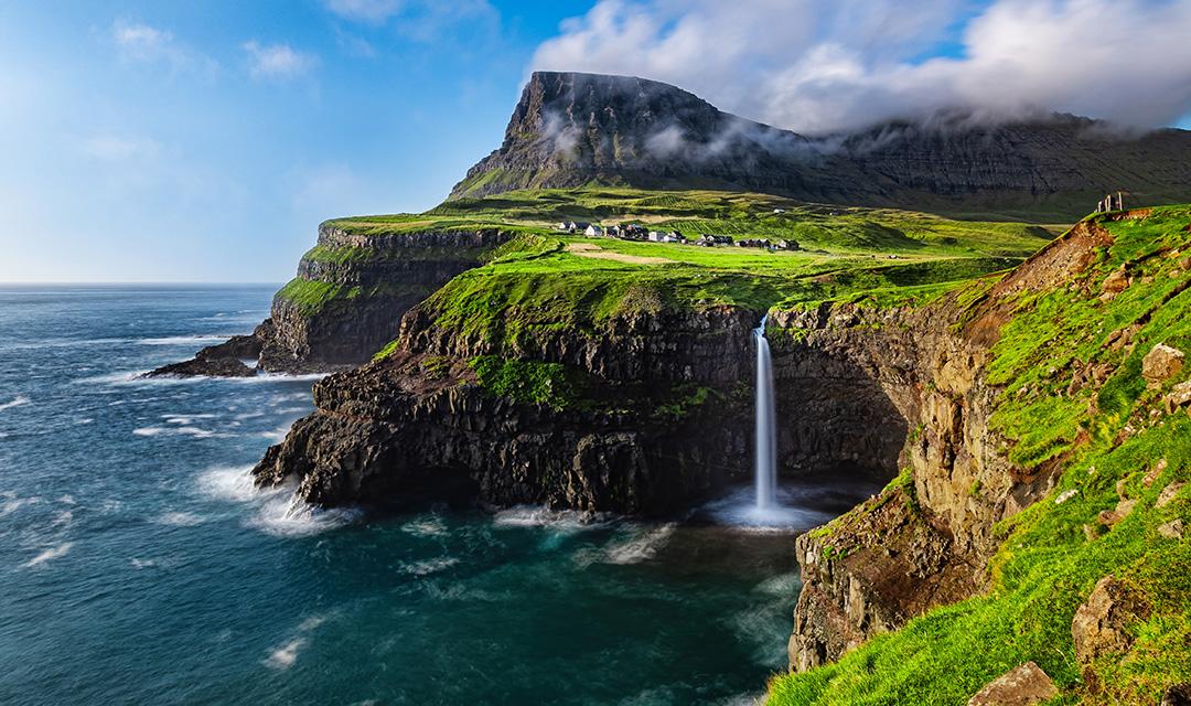 Article Cards Featured Image The Mulafossure waterfall on a sunny day in the Faroe Islands