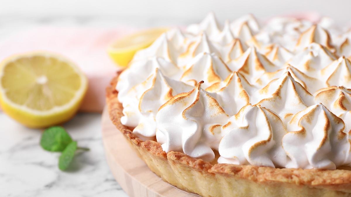 Article Cards Featured Image Serving board with delicious lemon meringue pie on white marble