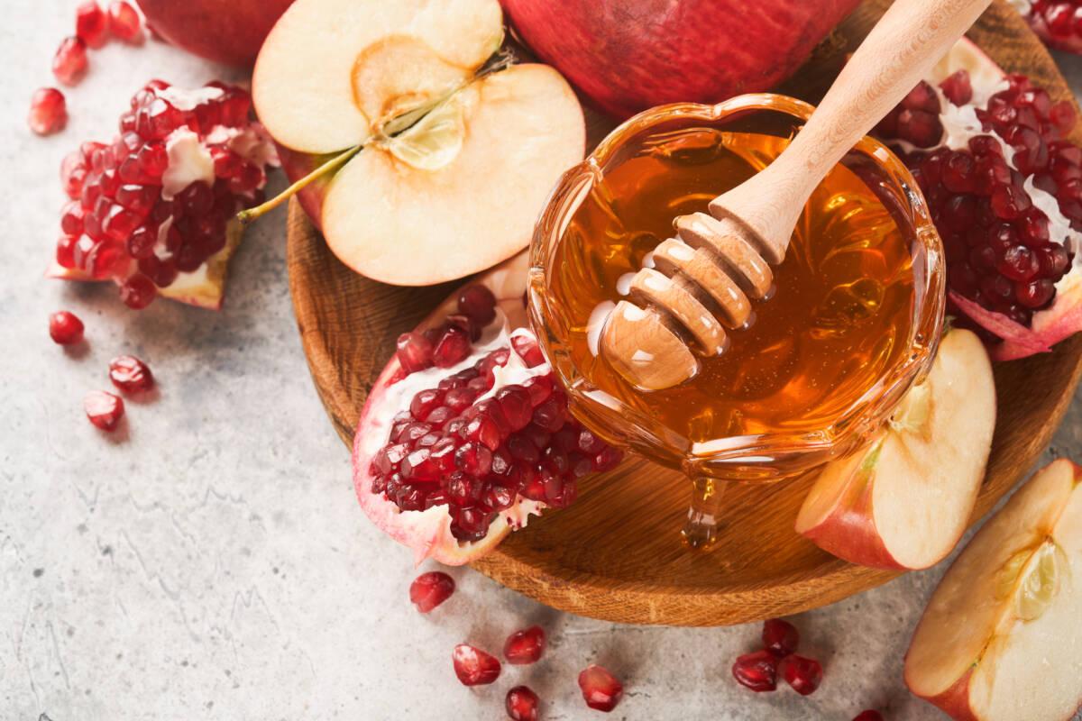 Article Cards Featured Image Rosh Hashanah. Pomegranate, apples and honey traditional products for celebration on rustic grey background. Jewish Autumn Rosh Hashana celebration. Jewish holiday Rosh Hashana design. Selective focus