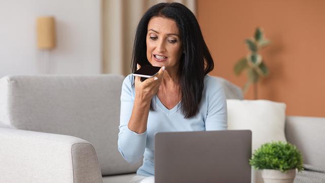 A woman practicing delivering a eulogy into her phone.