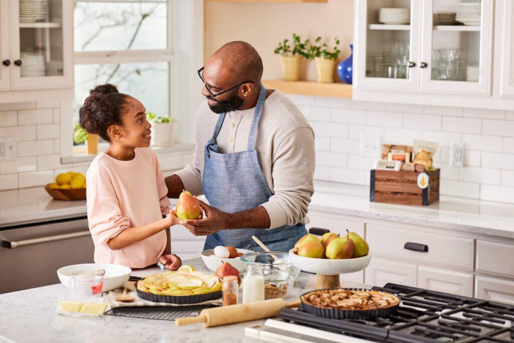 Cooking therapy with a girl and her father baking in the kitchen.