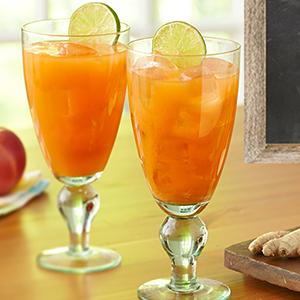 Two carrot juice cocktails on a table.