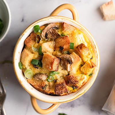 Breakfast for dinner with an egg strata in a small dish.