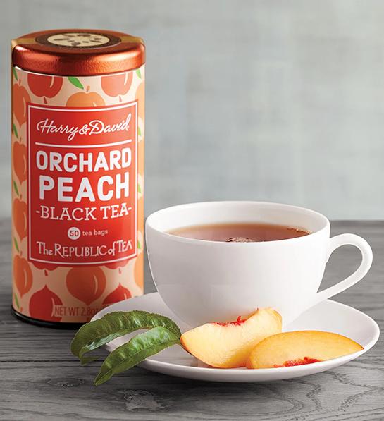 Tin of peach tea next to a cup of tea for a tea party.