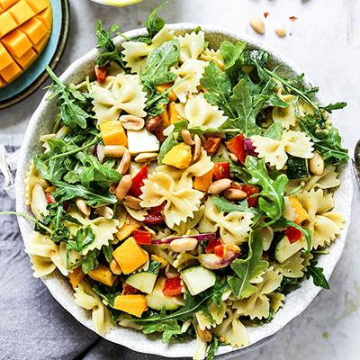 Mango recipes with a bowl of mango pasta salad.