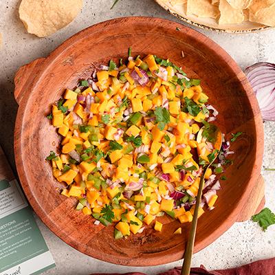 Mango salsa in a wooden bowl.